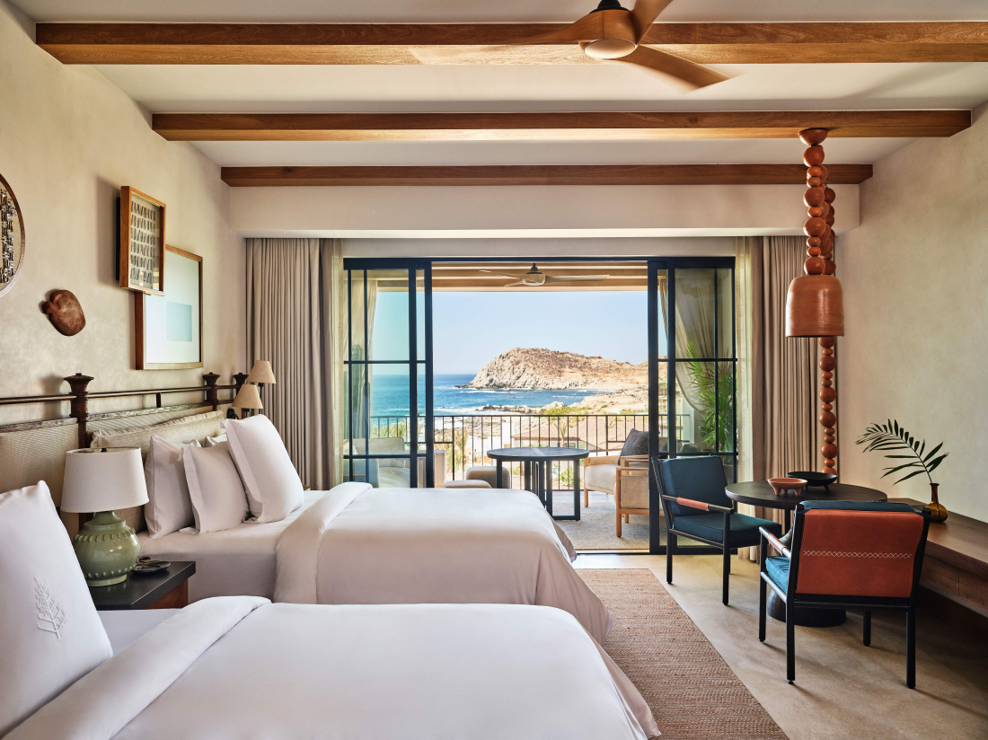 An interior view of a four seasons hotel room in cabo del sol with a breathtaking seaside cliff view